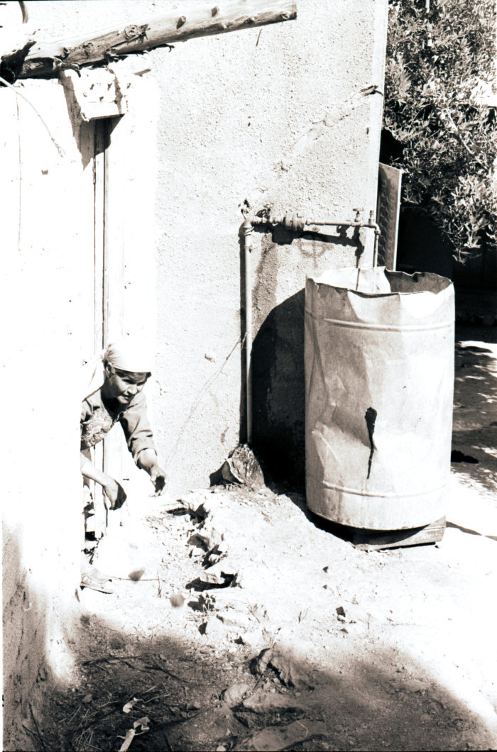 A Woman Standing Right by her House Door 