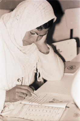 A Woman Receiving Education on Reading and Writing 