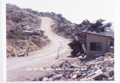 An unpaved bystreet; with ruins on the side