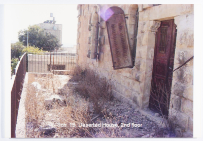 A balcony on the second floor of a deserted house