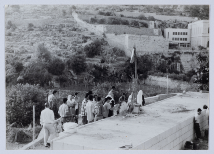Placing a Flag Atop the Shaheed's Grave 