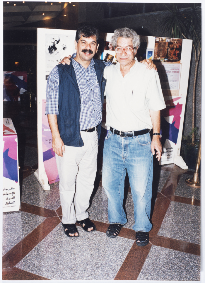 A photograph of the late Palestinian director Mustafa Abu Ali with a friend at the 7th Ismailia International Film Festival