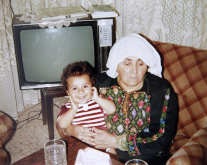 A Photograph of Dalal abu Laban Holding A Child in Dheisheh Palestinian Refugee Camp