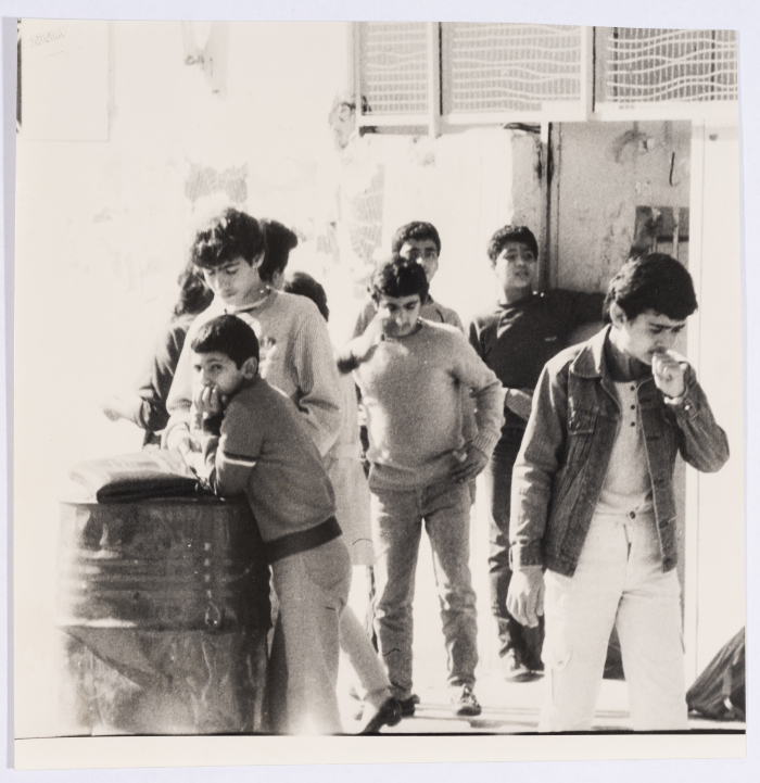 A Group of Youth Standing in front of a Gate 