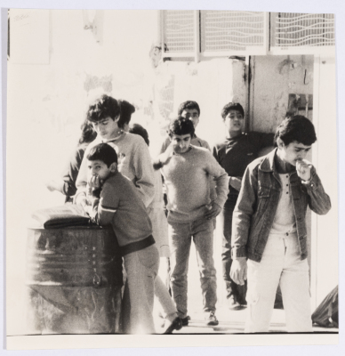 A Group of Youth Standing in front of a Gate 