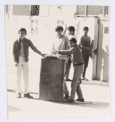 A Group of Youth Standing in front of a Gate 