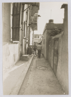 Two Men Walking inside the Alleys of One of the Palestinian Refugee Camps in Lebanon