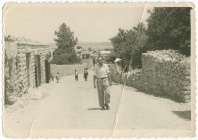 A Photograph of a Man Walking in the Streets of Birzeit 