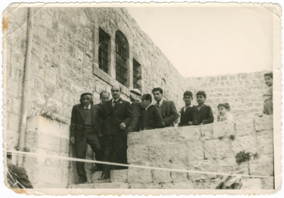 A Photograph of People at an Old House in Birzeit 