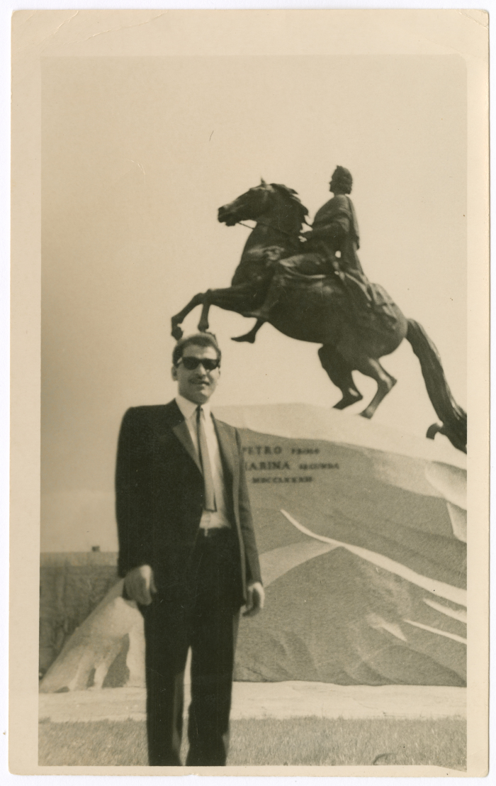 A man from Khateb Family in front of a statue of a horse; ridden by Caesar, in Saint Petersburg