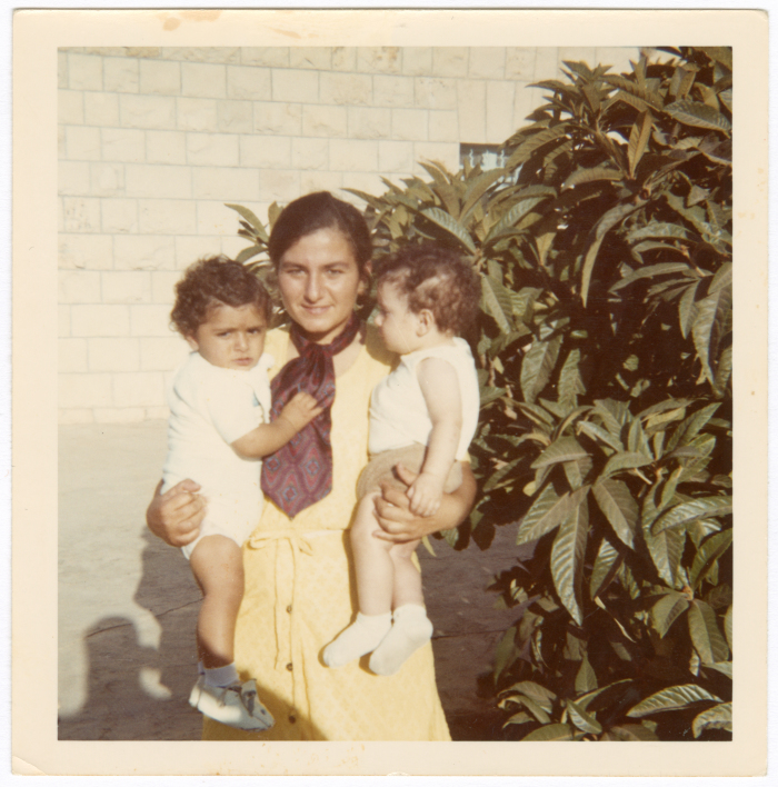 A girl holding two babies