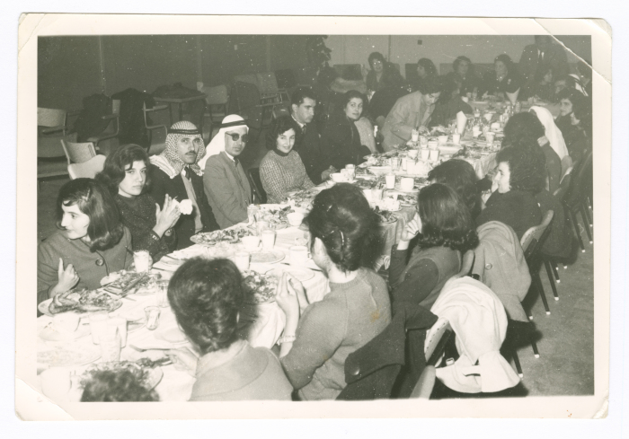 A photograph of men and women at a meeting