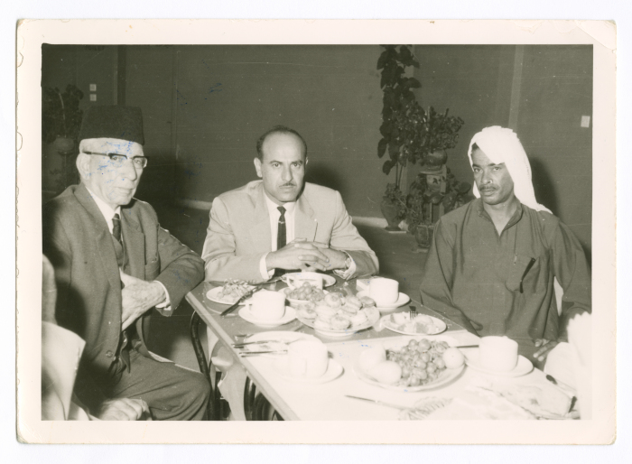 A photograph of men having a discussion