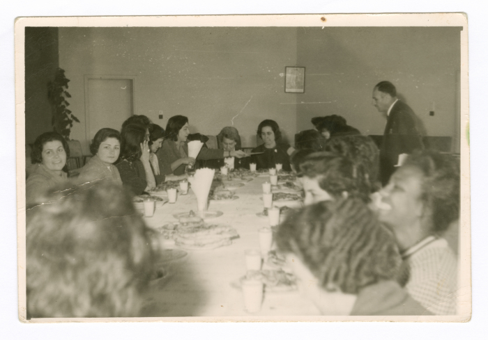 A photograph of men and women at a meeting