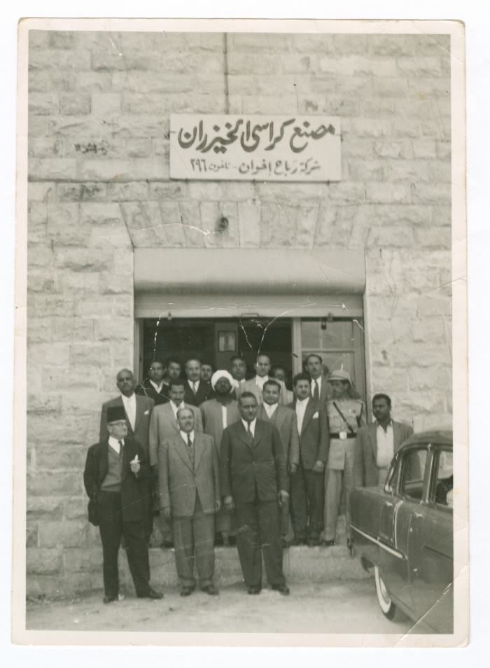 A photograph of men in front of al-Khaizarán Charis Factory