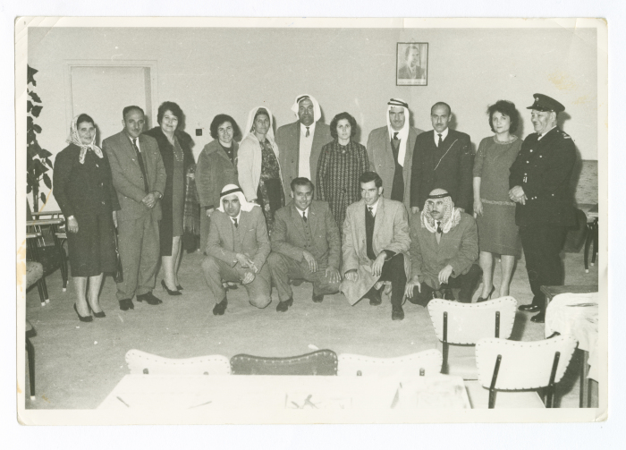 A photograph of men and women at a meeting