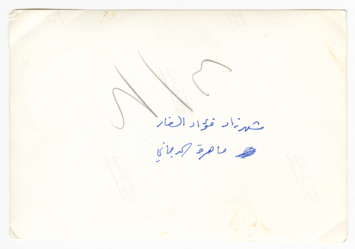 A photograph of men and women at a meeting