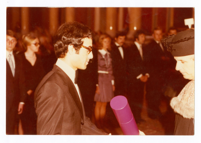 A photograph of a student at his graduation ceremony