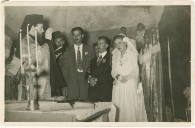 Newlyweds listening to a clergyman giving a speech at the wedding ceremony