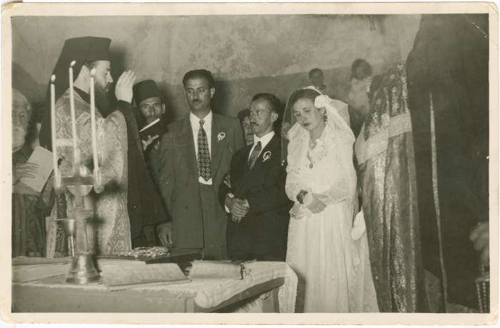 Newlyweds listening to a clergyman giving a speech at the wedding ceremony