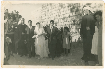 A married couple with their relatives at a wedding