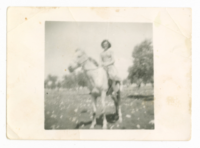 A woman riding a horse