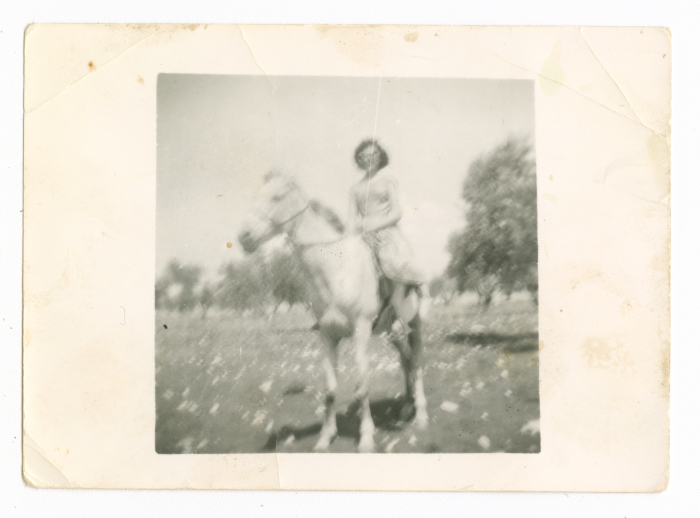 A woman riding a horse