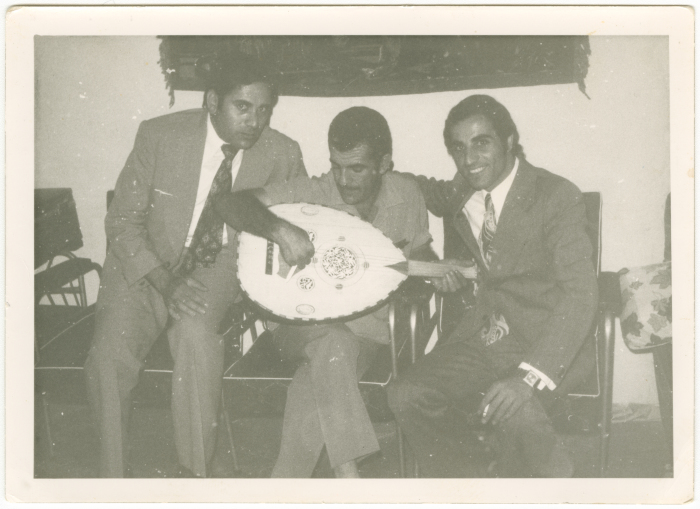 A man playing the Oud with his friends