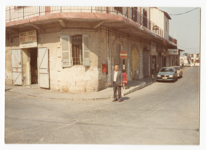 A man standing in front of al-Led Municipality Building