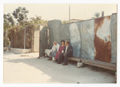 A man and two women in front of their house in al-Led; which was confiscated by the Israeli Occupation