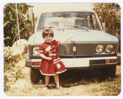 A Little Girl Standing Next to her Father