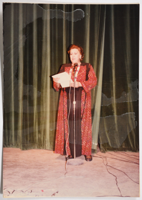 Ms Najla Yassin receiving a speech.