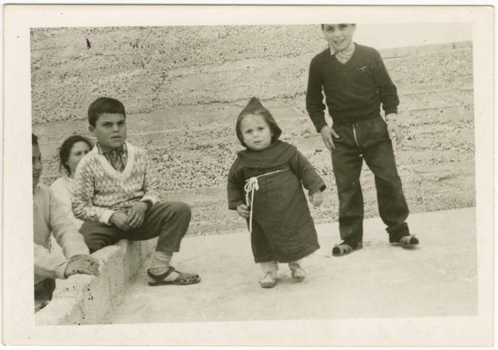 Children; one of which in priests' uniform