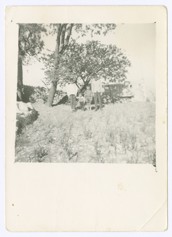 Siblings in front of their house in Silwad Village