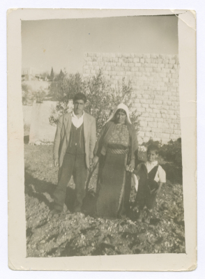 A mother in the traditional dress with two of her children