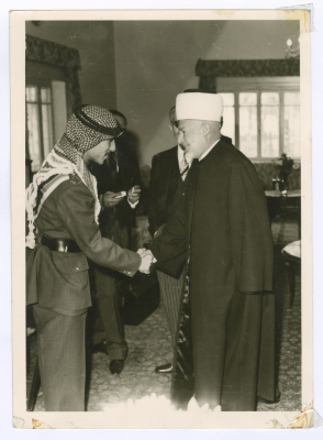 A clergyman handshakes with Prince Mohammad; of Jordan