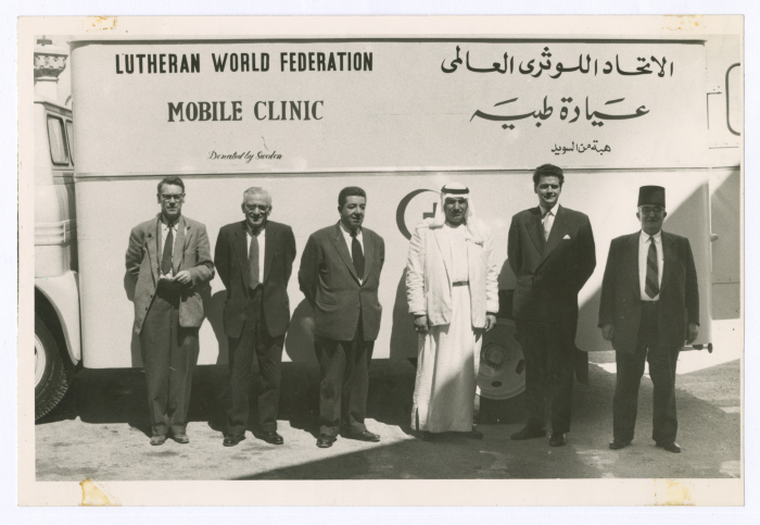 Men in front of a mobile clinic