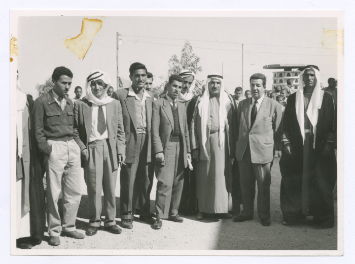 A photograph of men after the Lutheran Union distributed clothes to school students