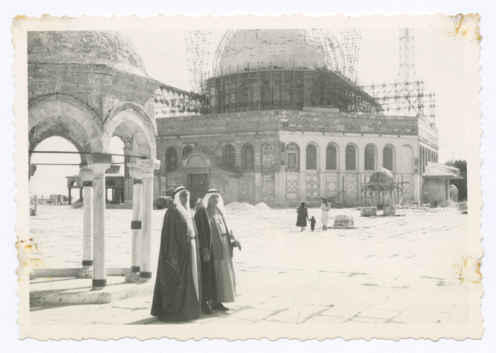 Two men in front of the Dome of the Rock; being painted with gold