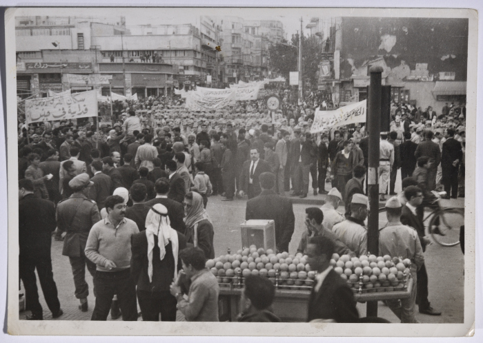 A crowd of demonstrators marching with banners against The Central Treaty Organization (CENTO) or Baghdad Pact in Damascus