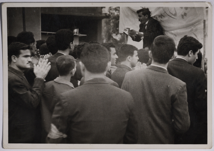 A protester cheering in one of the demonstrations, surrounded by people repeating his cheers