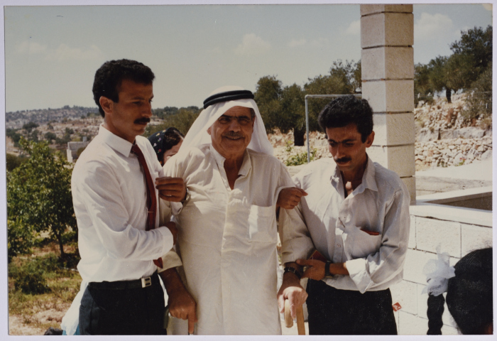Rajih al Salfeety leaning on his daughter's groom and his brother