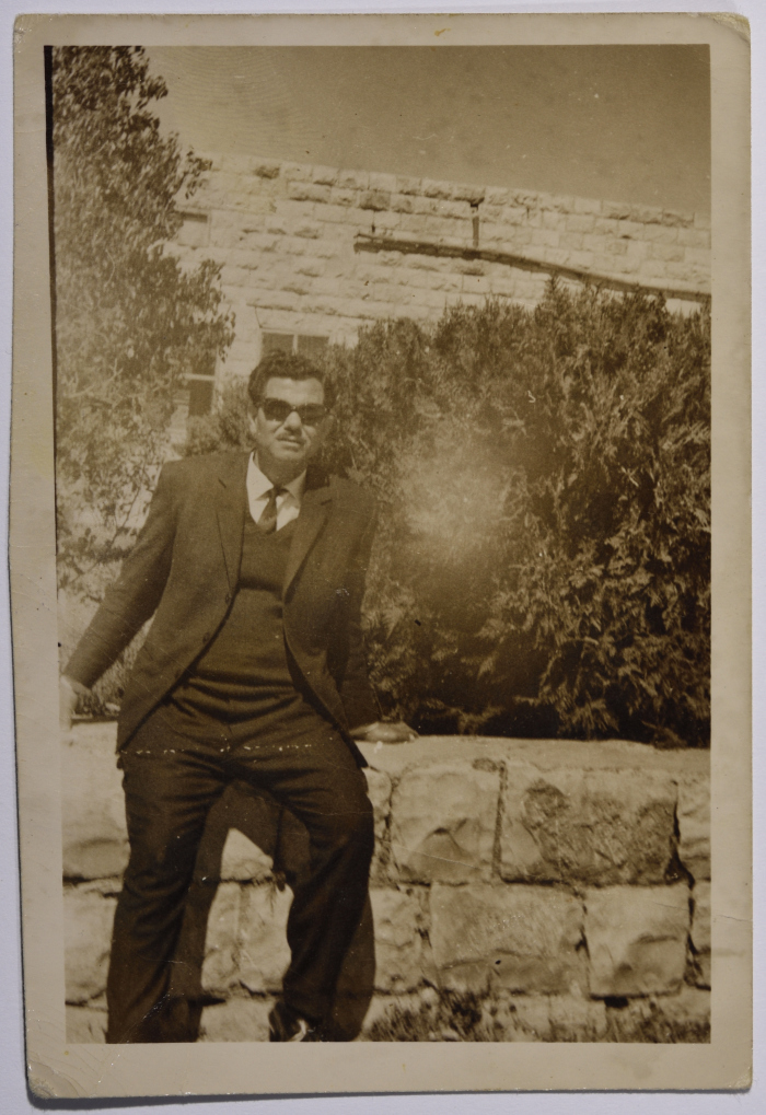 Rajih al Salfeety sitting on a wall of Salfit School for Boys