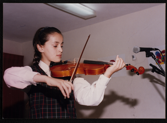 A Photograph of a Student Playing the Violin 