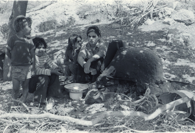 A Mother with her Children Gathered by a Taboon in Kobar, Ramallah