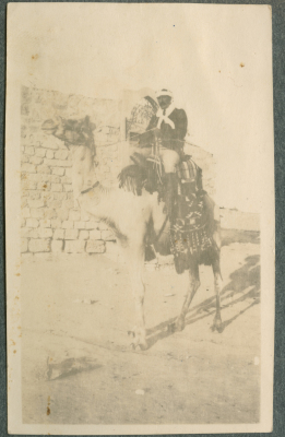 A Photograph of a Man Riding a Camel