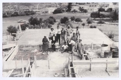 Members of Abu Al -Najeeb with a several construction workers on the roof of their house, Rifidia, 1956