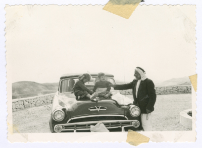 A Man and Two Kids Sitting on Muhammad Salem adh-Dhuwayb's Car