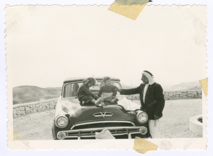 A Man and Two Kids Sitting on Muhammad Salem adh-Dhuwayb's Car