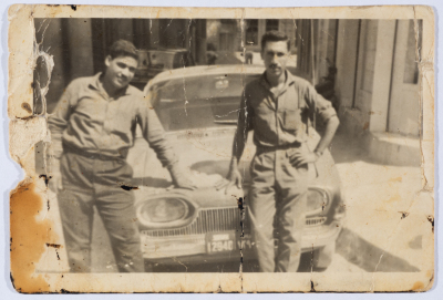 Two Drivers Standing by a Taxi for Etimad Taxi Service 